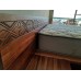 Fijian motif curving King size bed, Raintree, stained, integrated bedsidetables.